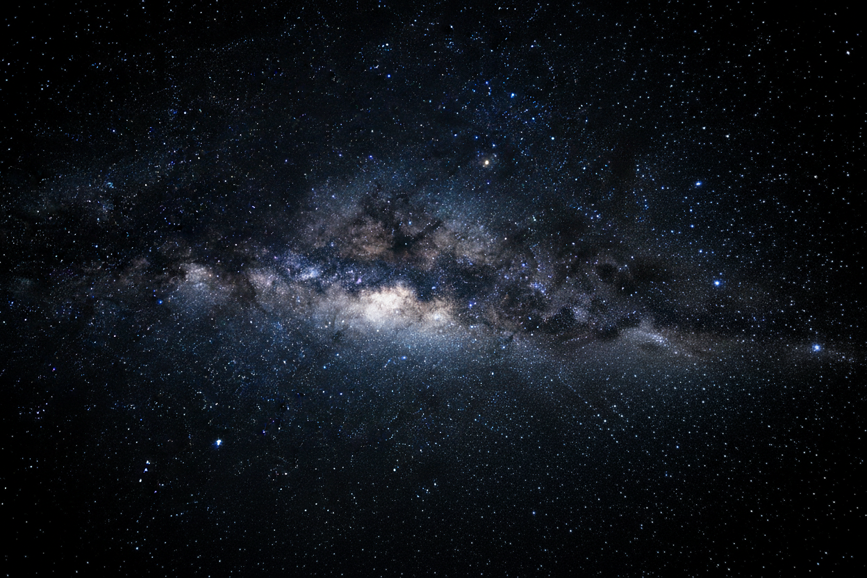 a dark midnight sky view from space of the stars